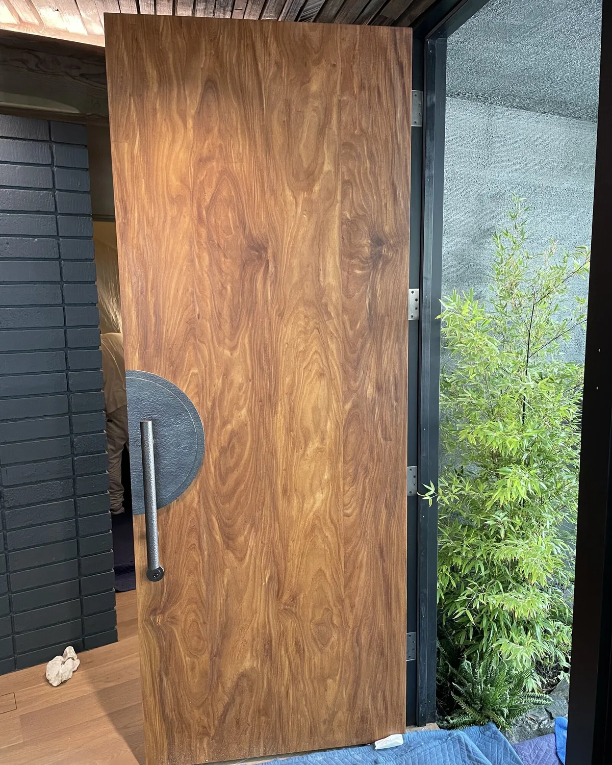 Refinished front door and entryway with high-gloss paint and brass hardware