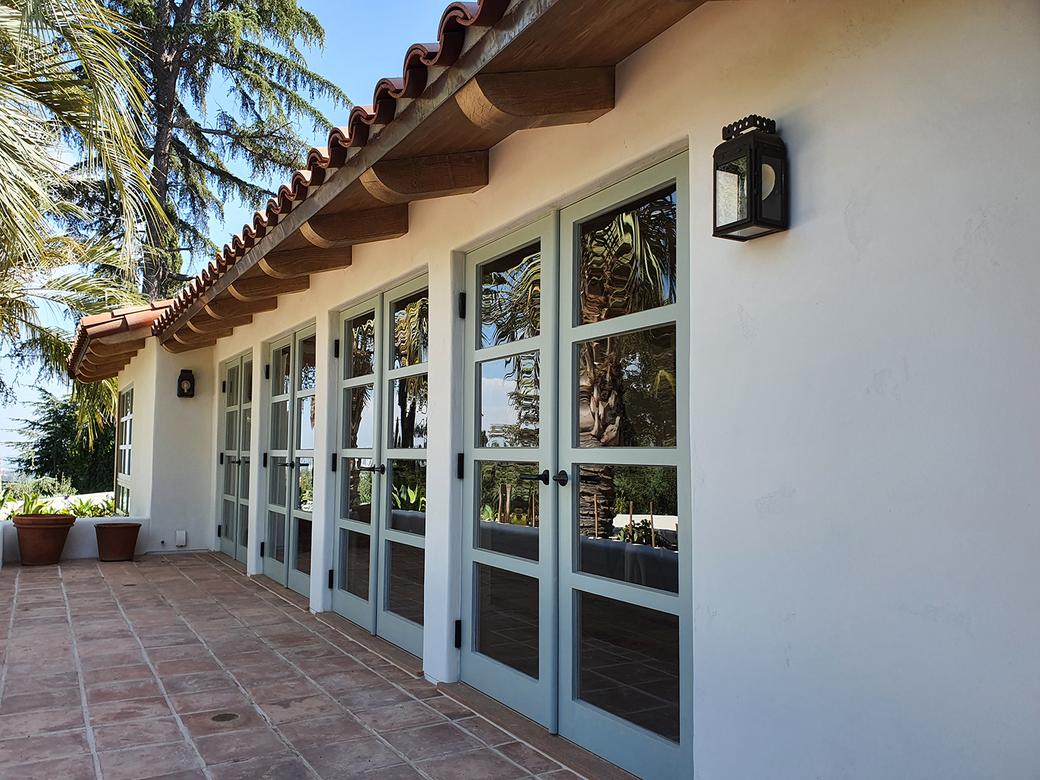 Classic colonial home exterior with newly painted white clapboard and black shutters