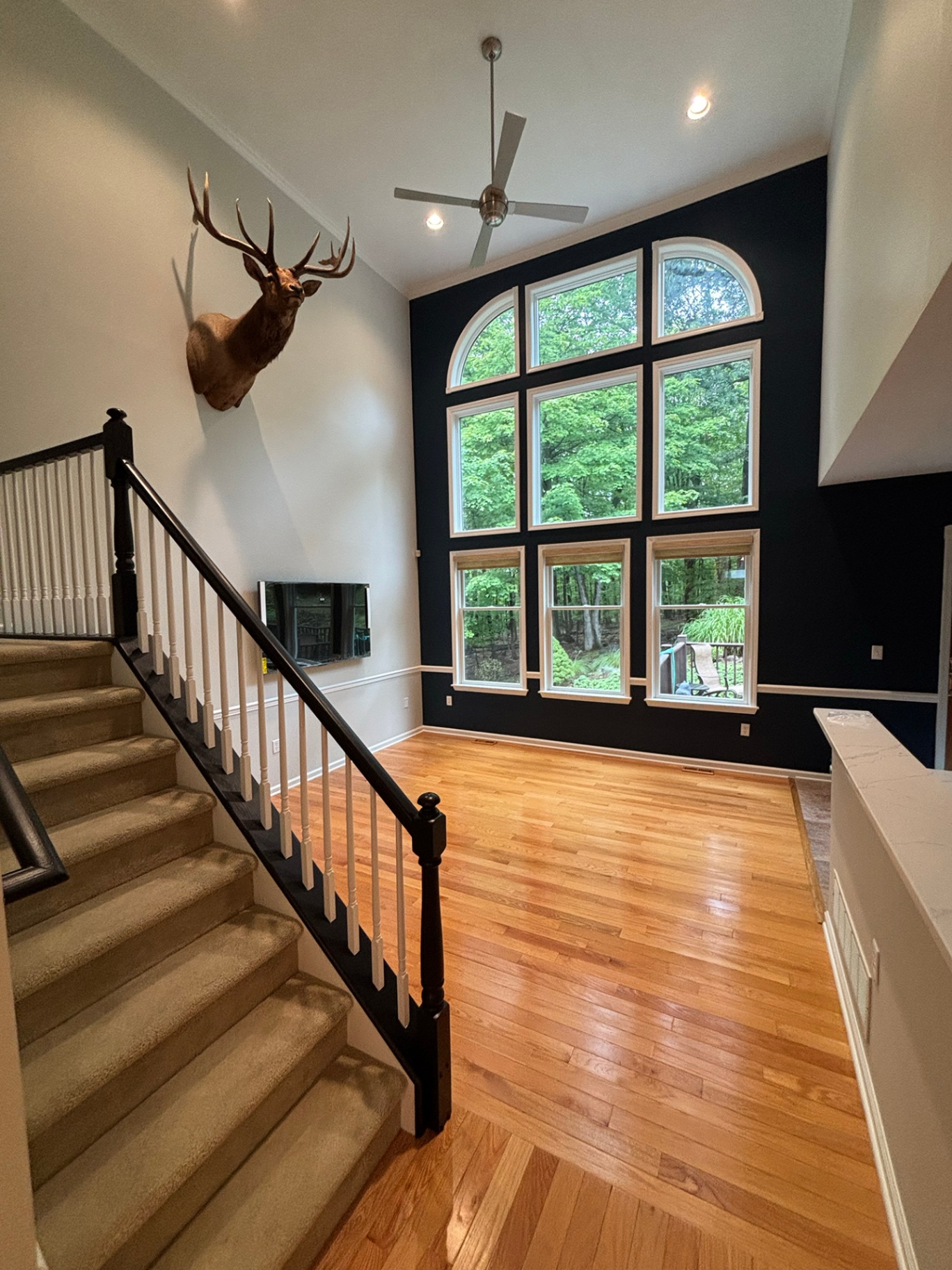 Bedroom interior repaint in soft neutral tones with painted crown molding and baseboards