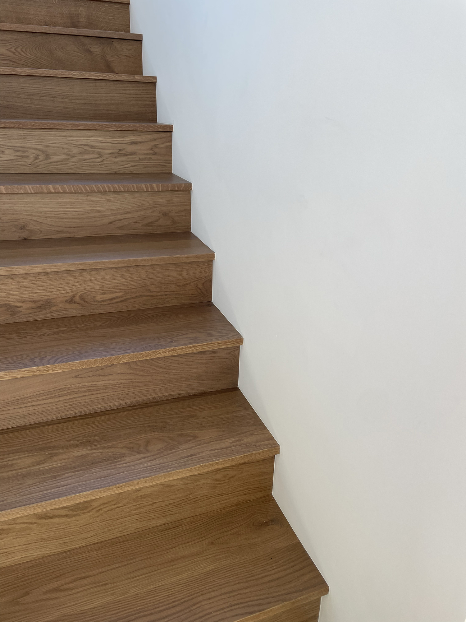 Painted hallway with fresh white ceiling, warm wall color, and clean trim lines