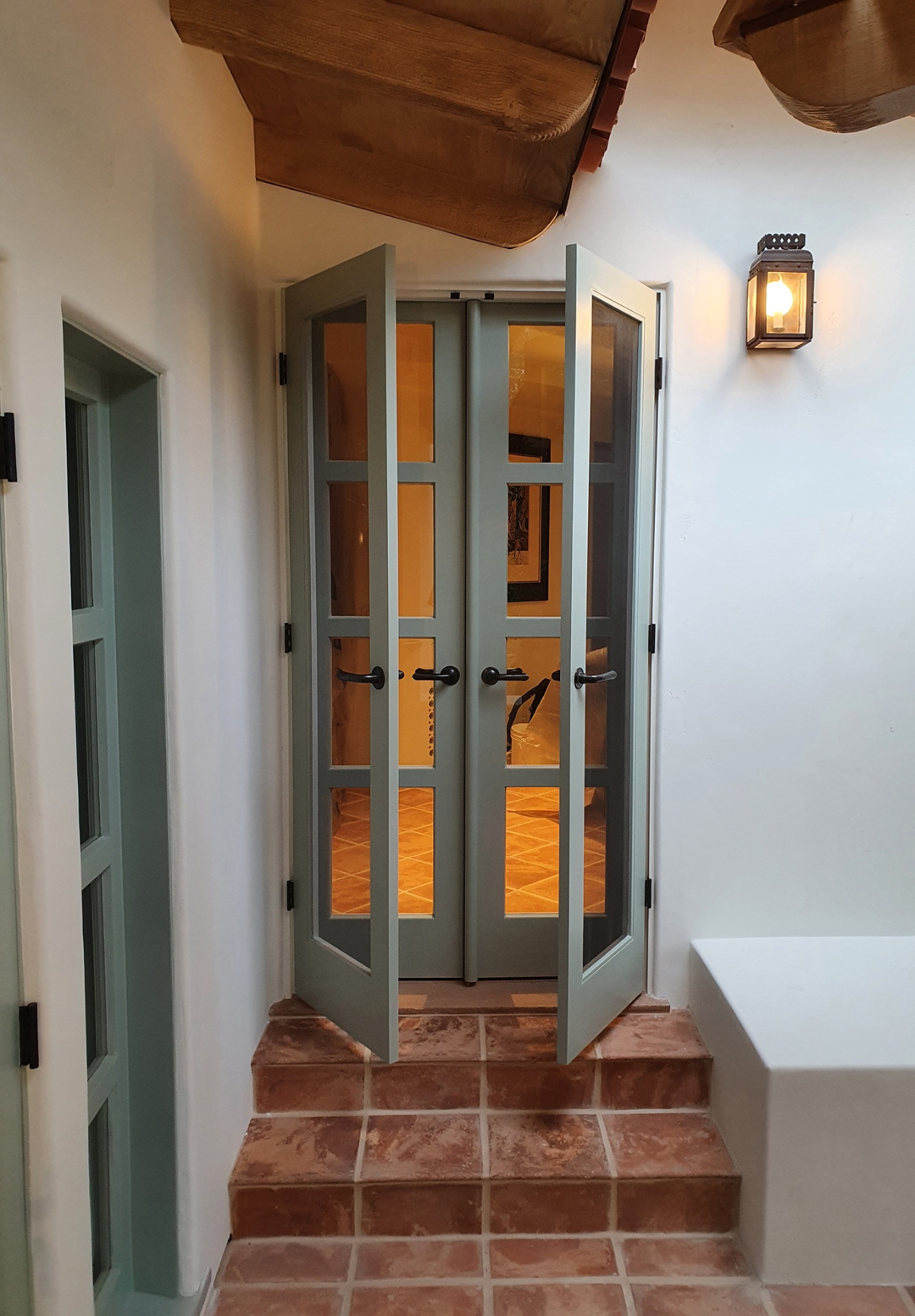 Refinished front door in a warm neutral tone with painted casing and threshold